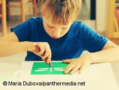 Photo: Boy with autism sitting and drawing