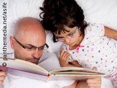 Photo: Father reads to his daughter