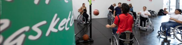 Photo: Several people playing wheelchair basketball in the Sports Center of the BRSNW at REHACARE; Copyright: Messe Düsseldorf/ctillmann
